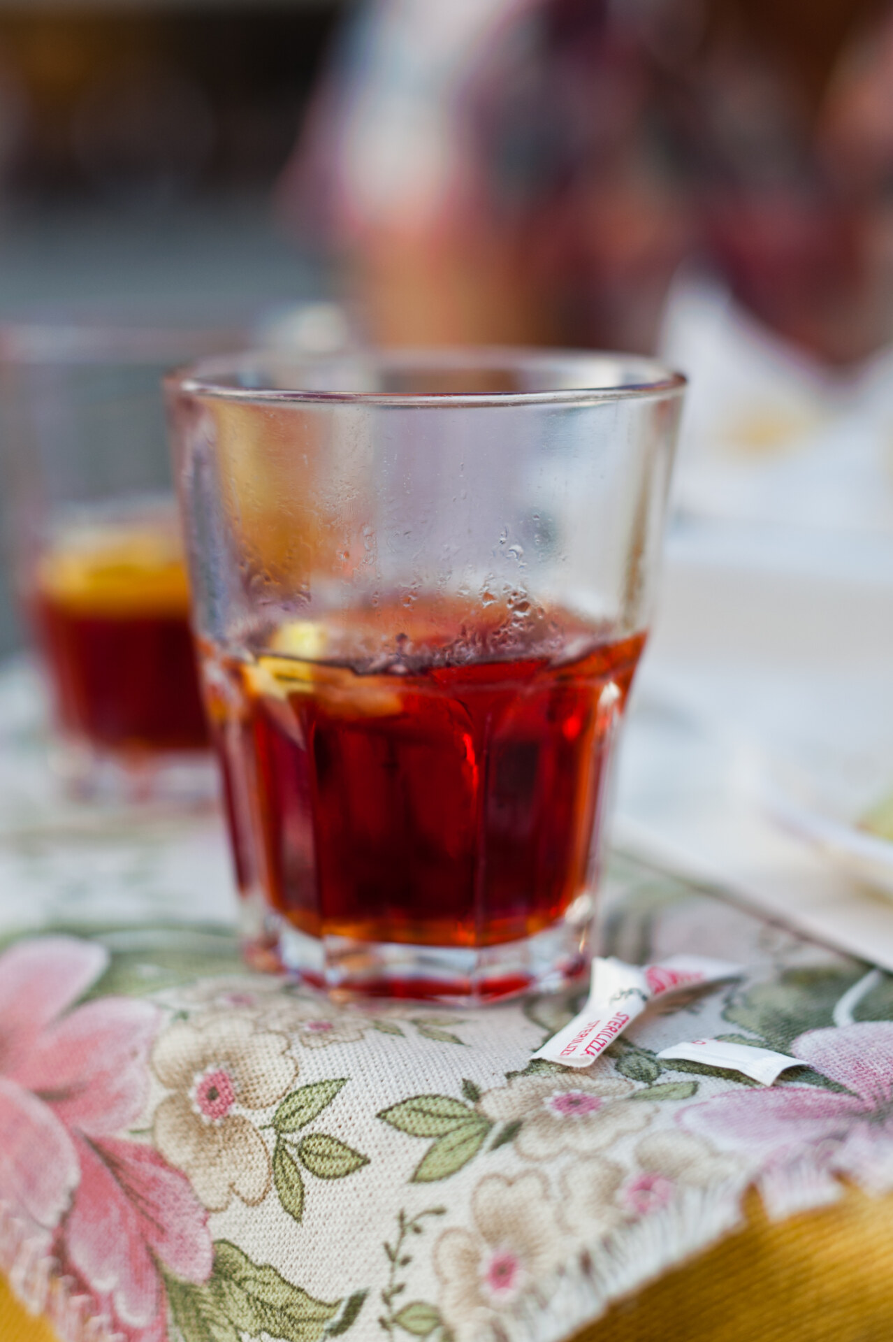 Typical italian cocktail campari spritz in a crystal glass with a orange slice in a bar in Padua Veneto in Italy