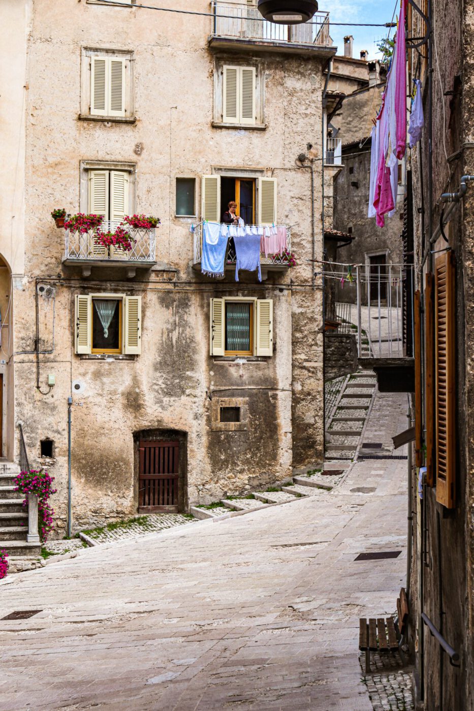 Rustic and old building facade with wooden windows and clothes hanging in Scanno Abruzzo in Italy