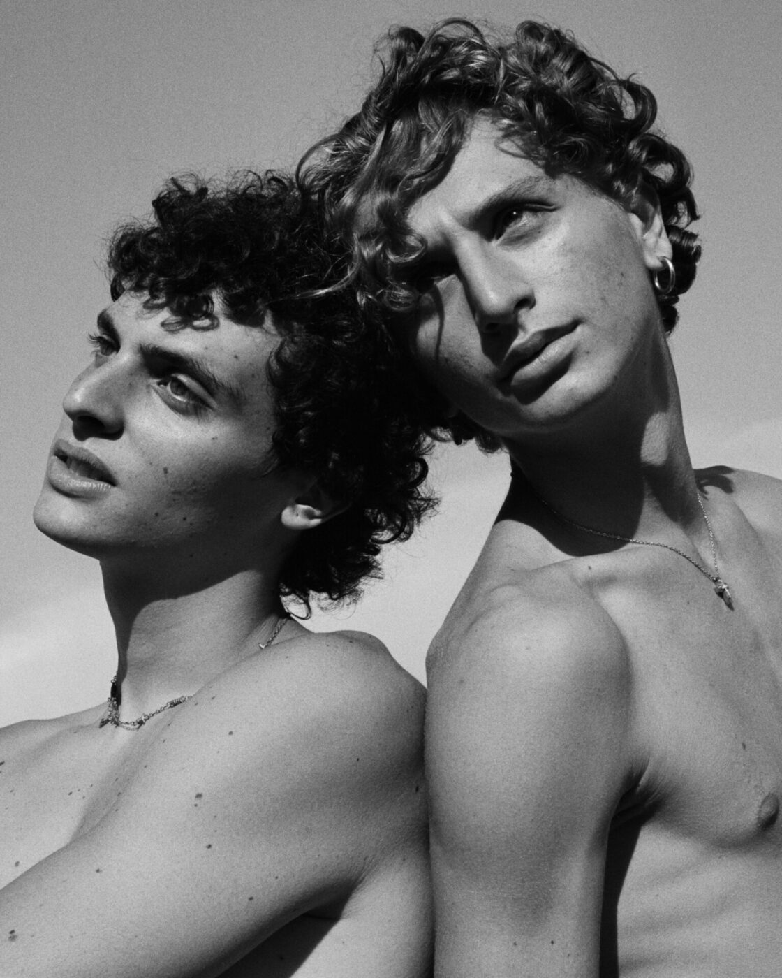 Close up to two men faces in Black & White at Napoli Campania in Italy, photographed by Brett Lloyd