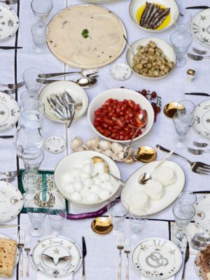 Laboratorio Paravicini's ceramic plates and bowls over a table with italian food