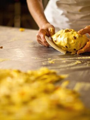 Baker kneading Traditional Italian Panettone bread dough at Vincente Delicacies (Bronte) 