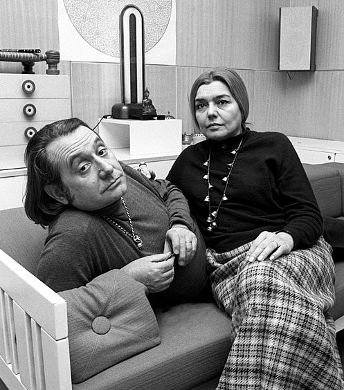 Italian architect and designer Ettore Sottsass sitting in his home with his wife, the Italian writer and translator Fernanda Pivano. Milan, March 1969