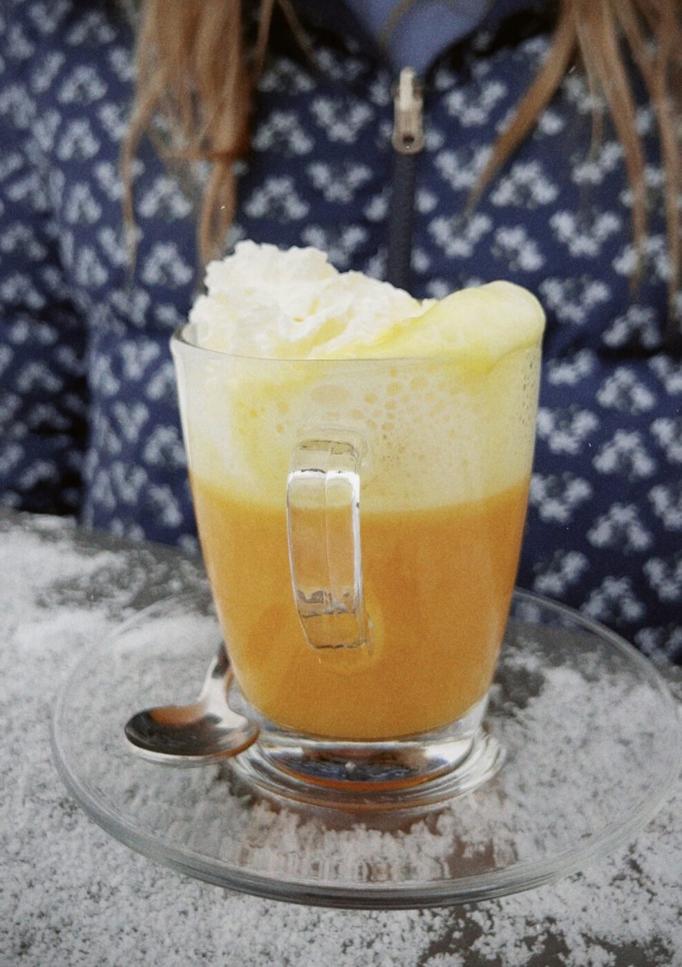 bombardino; yellow colored drink with whipped cream