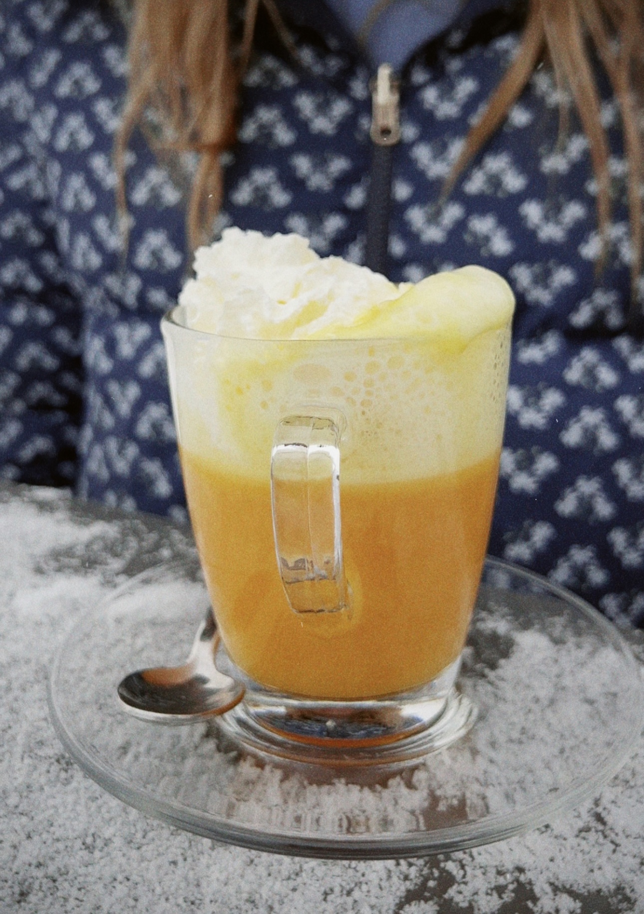 bombardino; yellow colored drink with whipped cream
