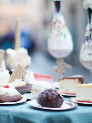 Table full of Italian dolci slices of cakes and gelato in Italian Pasticceria