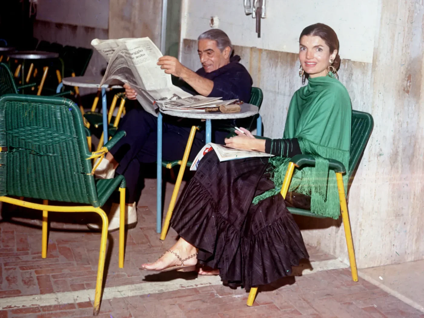Jacqueline Kennedy in a green cape wearing Canfora sandals
