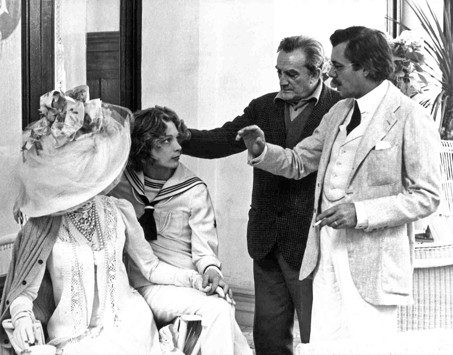 Photograph from the principal cinematography of the film Death in Venice. Here Silvana Mangano (face not visible), Björn Andrésen, Luchino Visconti and Dirk Bogarde.