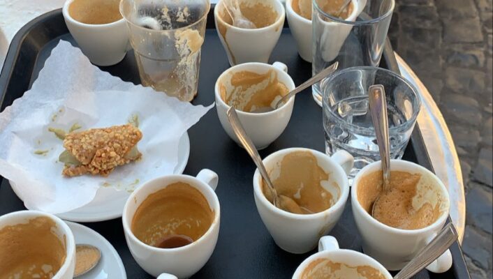 14 empty glasses (mainly espresso cups) on a small table outside at Caffè Sant Eustachio in Rome