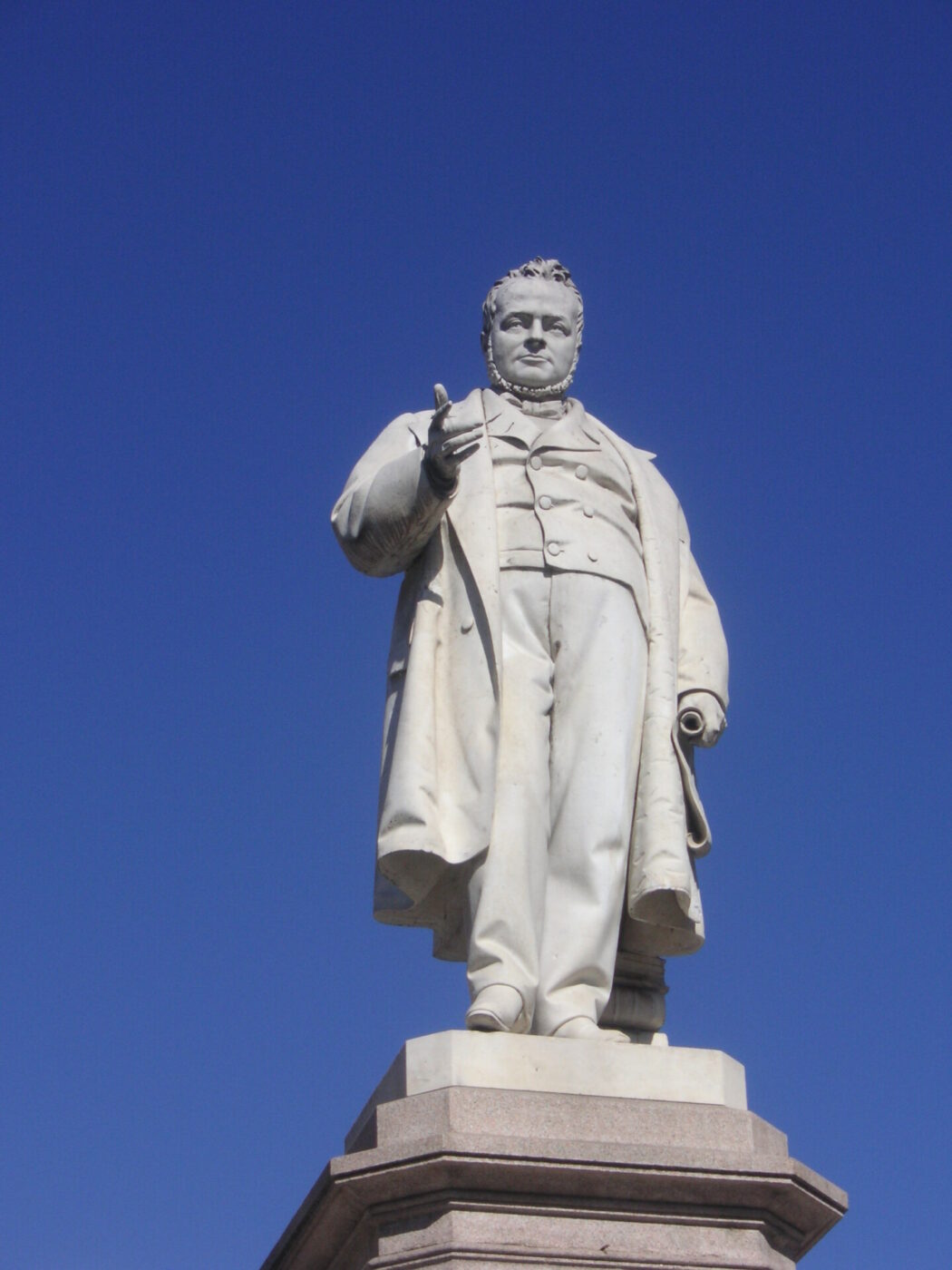 a statue of Cavour standing and pointing in Ancona