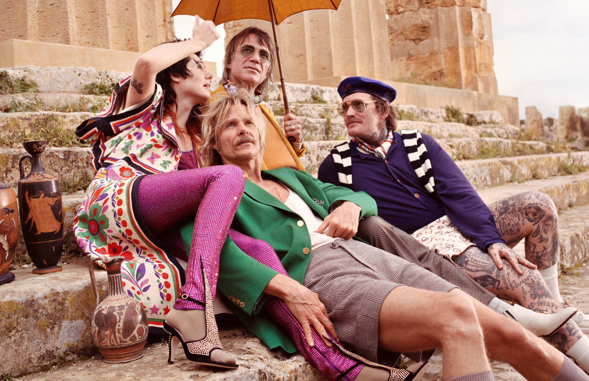 4 models on the steps of a monument wearing Gucci fall 2019 summery, floral clothing