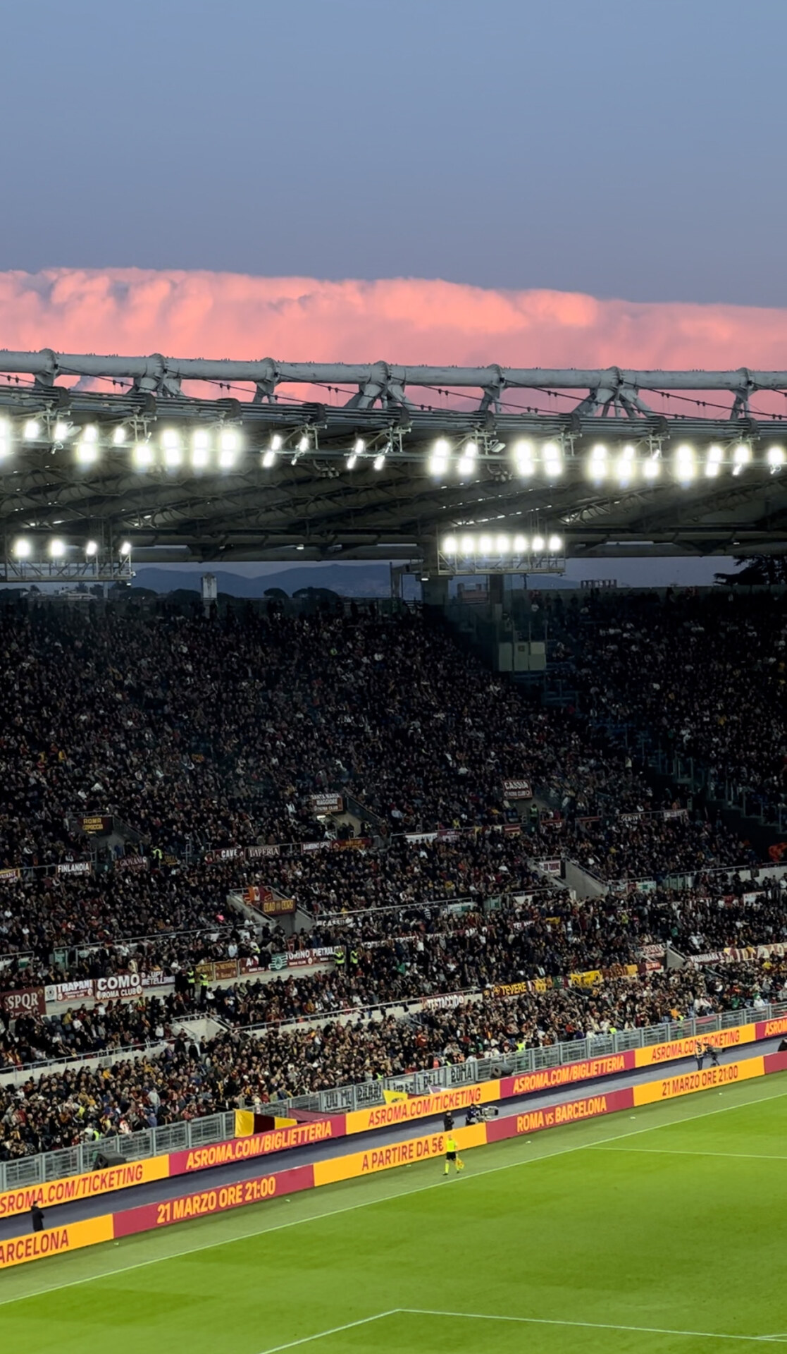 An Italian football stadium filled with spectators at sunset