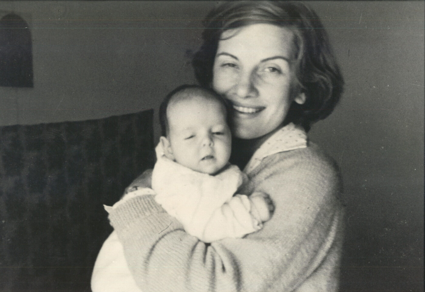 a vintage photo of a mom holding a baby