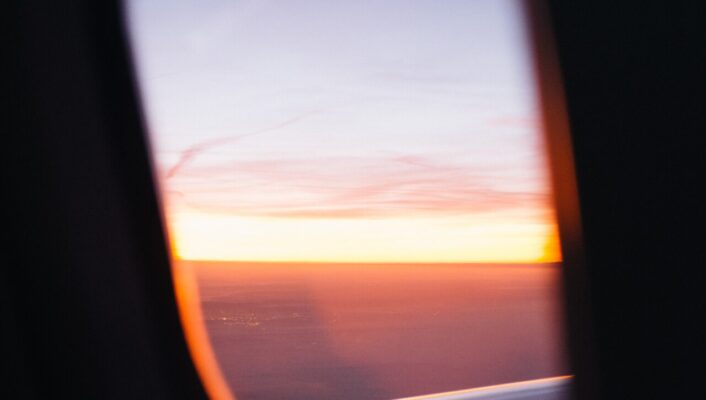 an image of a sunset out of a plane window