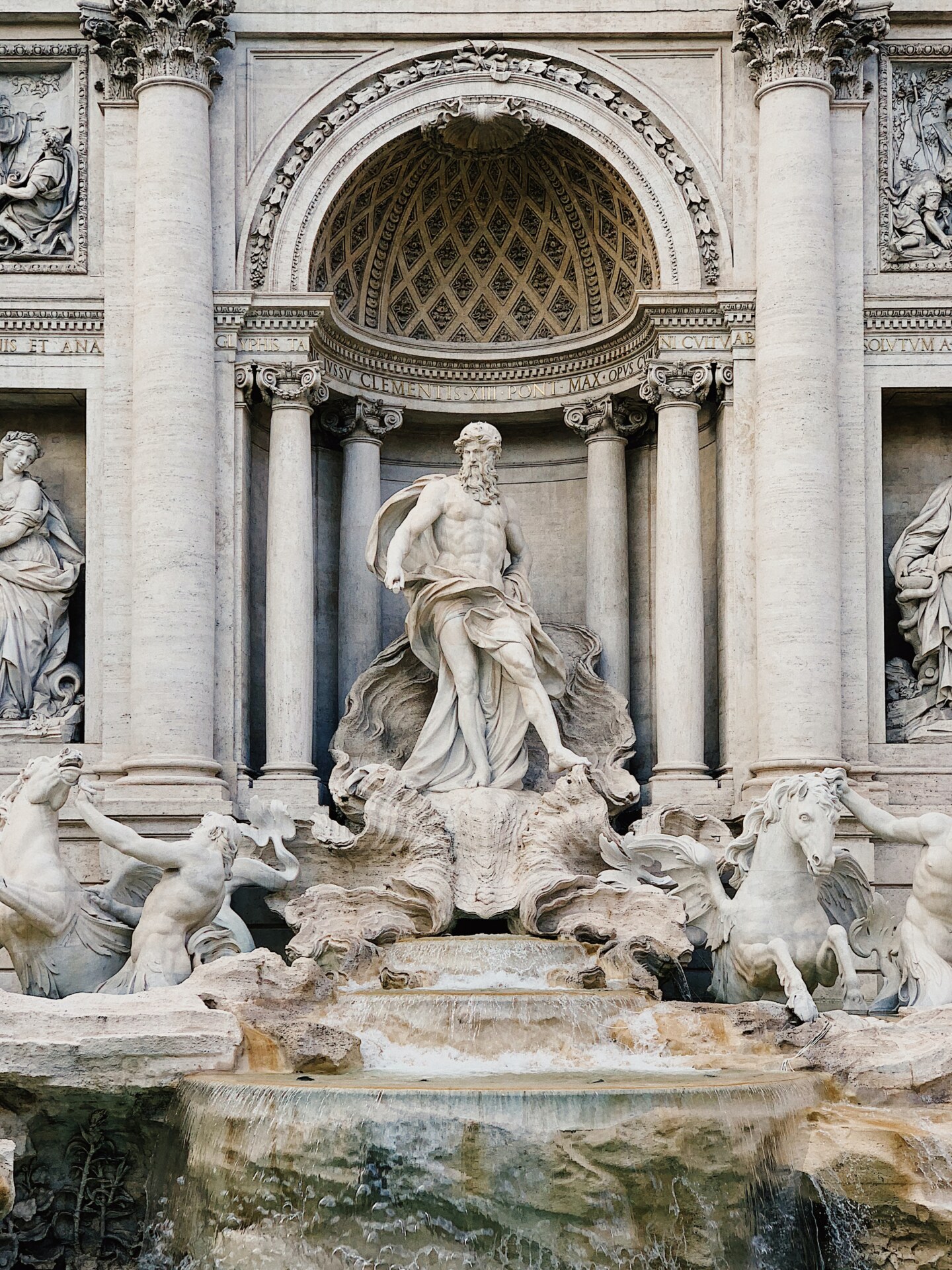 a close up image of the main statue in the center of the Fontana Di Trevi in Rome