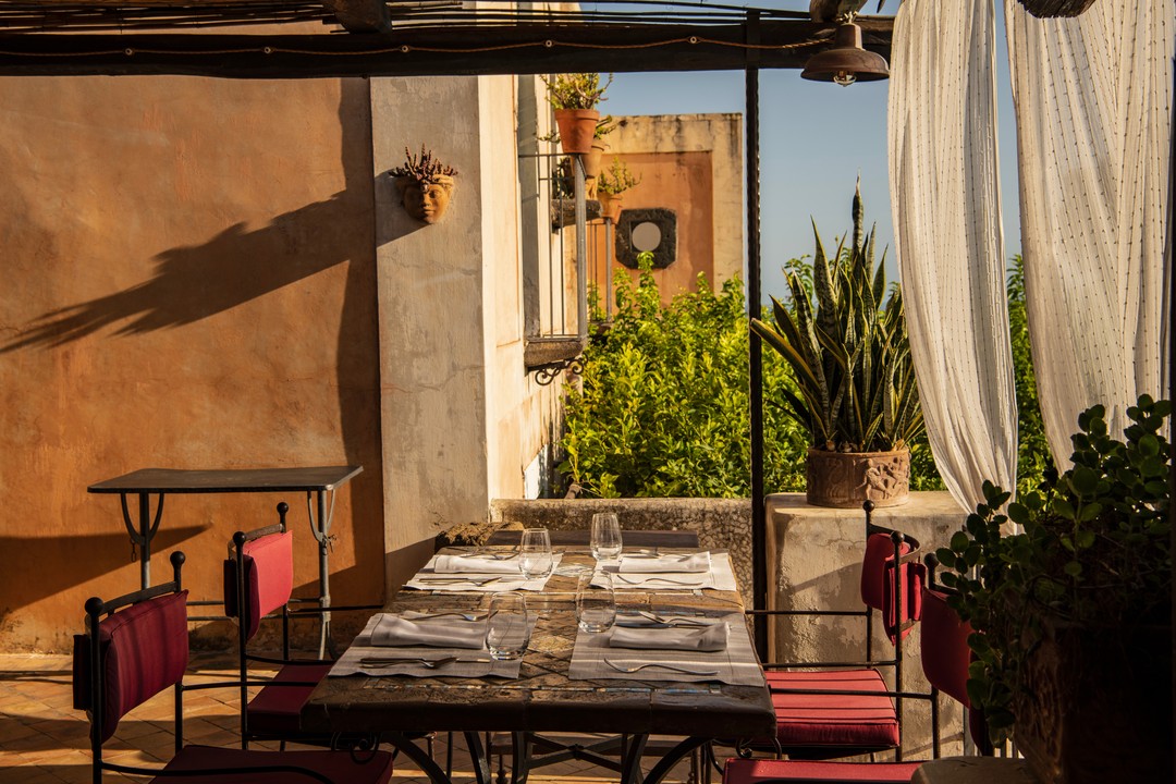 Hotel Signum - a very sunny photo taken of a table set on a balcony in Sicily