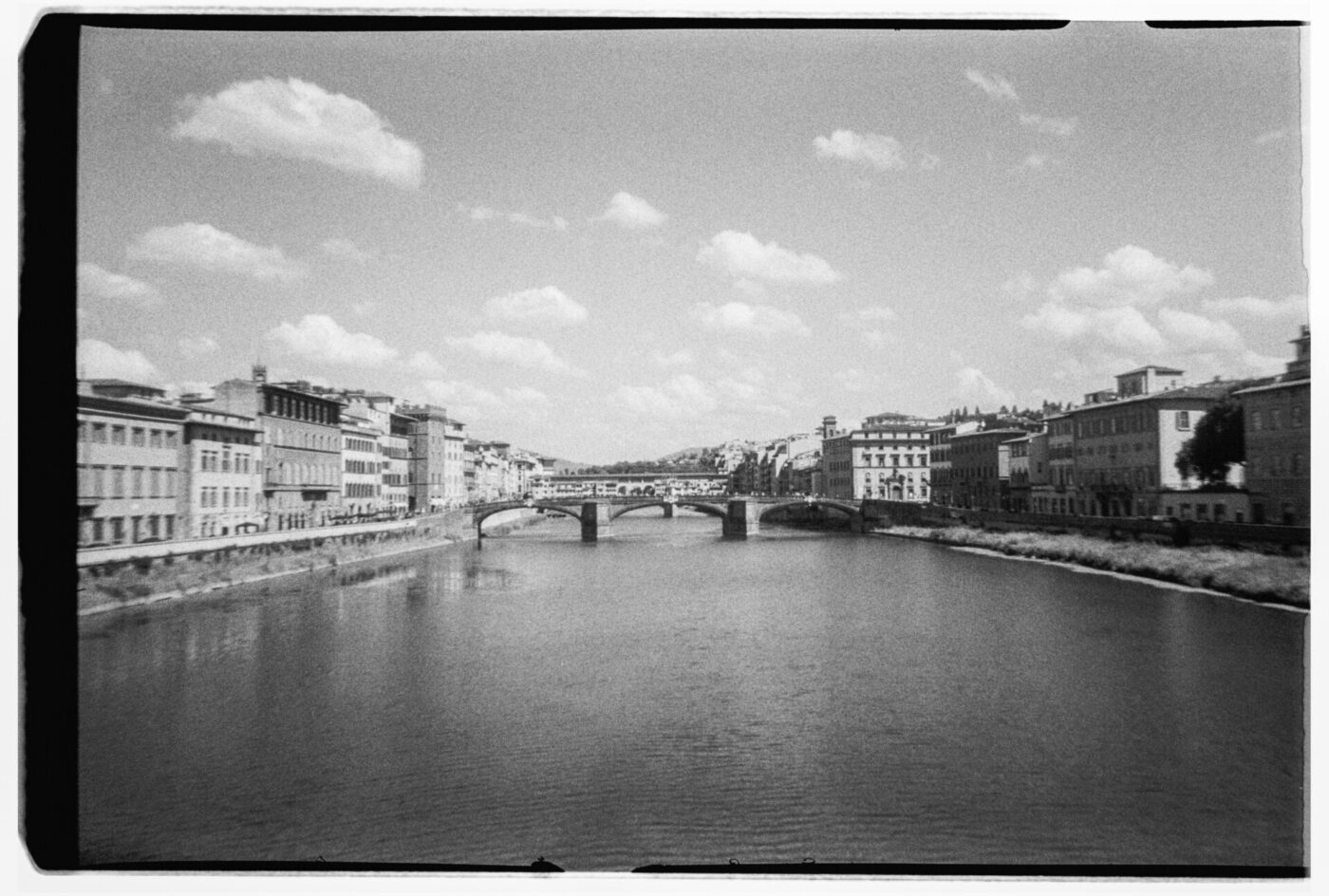 black and white photo of the river and main bridges in Florence by Gina Spinelli