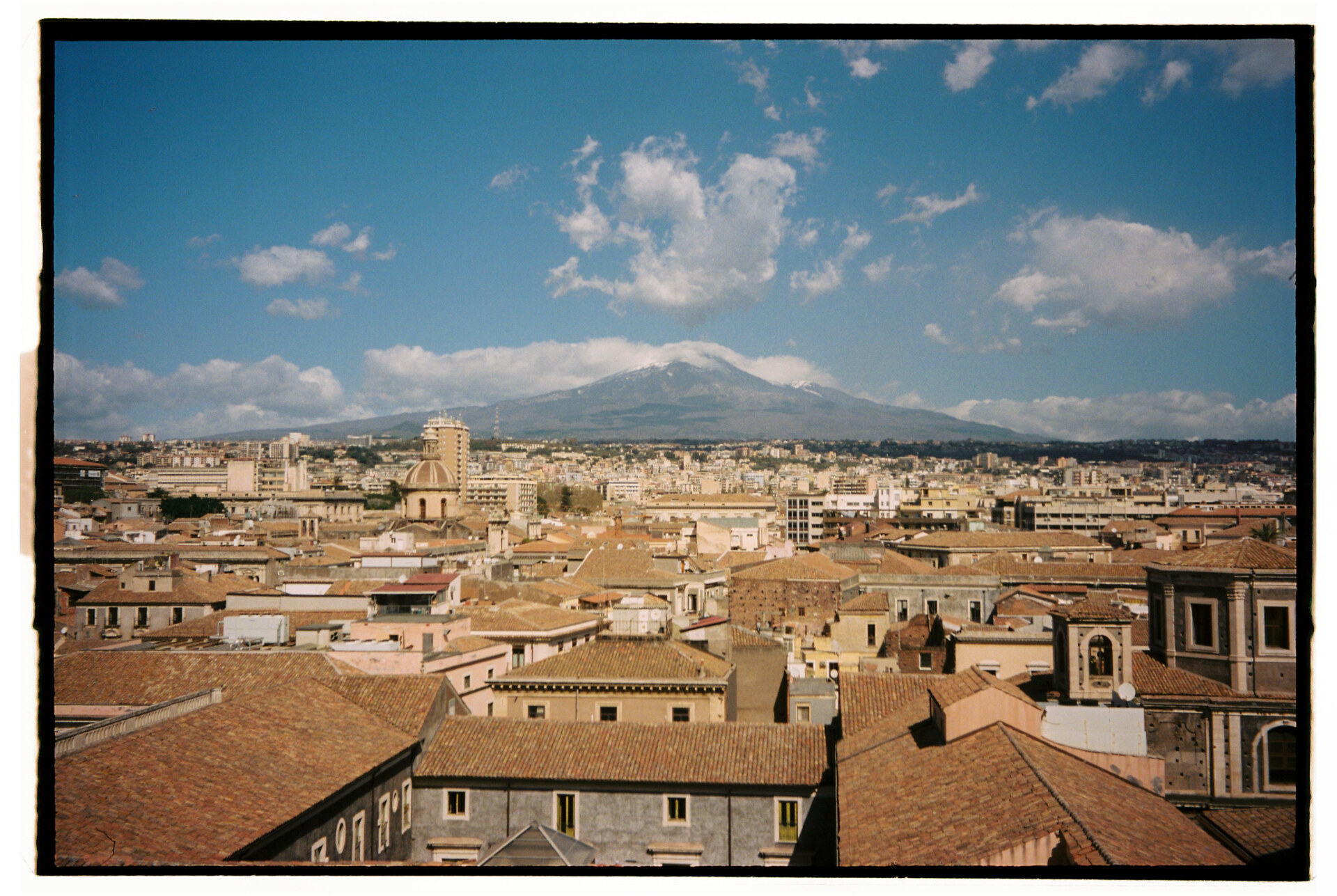 Photography by Gina Spinelli of mount etna beyond the city of Catania
