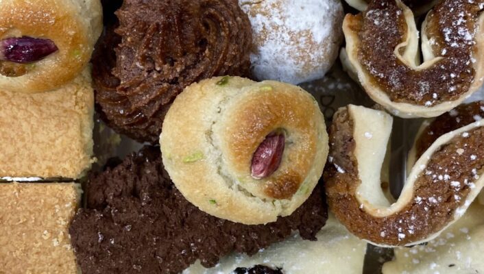 a closeup of various pastries covered in powdered sugar