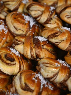 an image of cinnamon buns wrapped neatly into boys covered with big flaky salt at wild buns