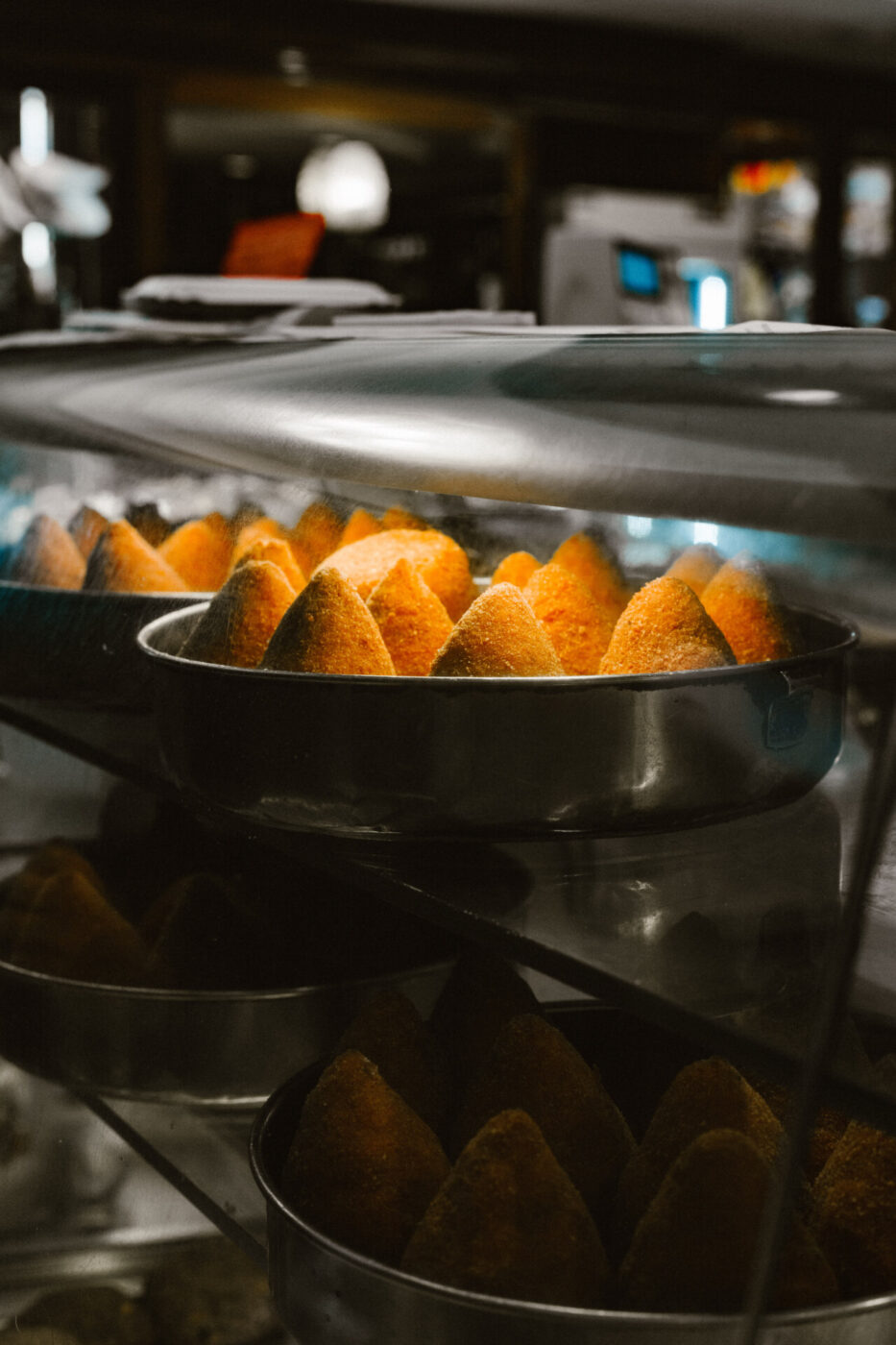 a tray of cone shaped arancini