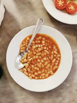 a plate of Fagioli all’Uccelletto - beans in a red sauce