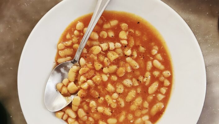 a plate of Fagioli all’Uccelletto - beans in a red sauce