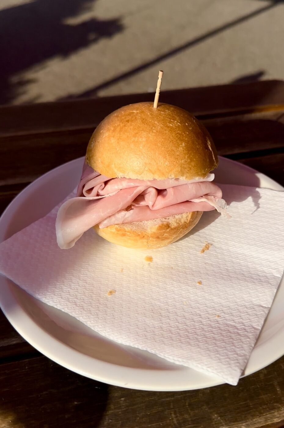 a smaller, round panino filled with prosciutto cotto