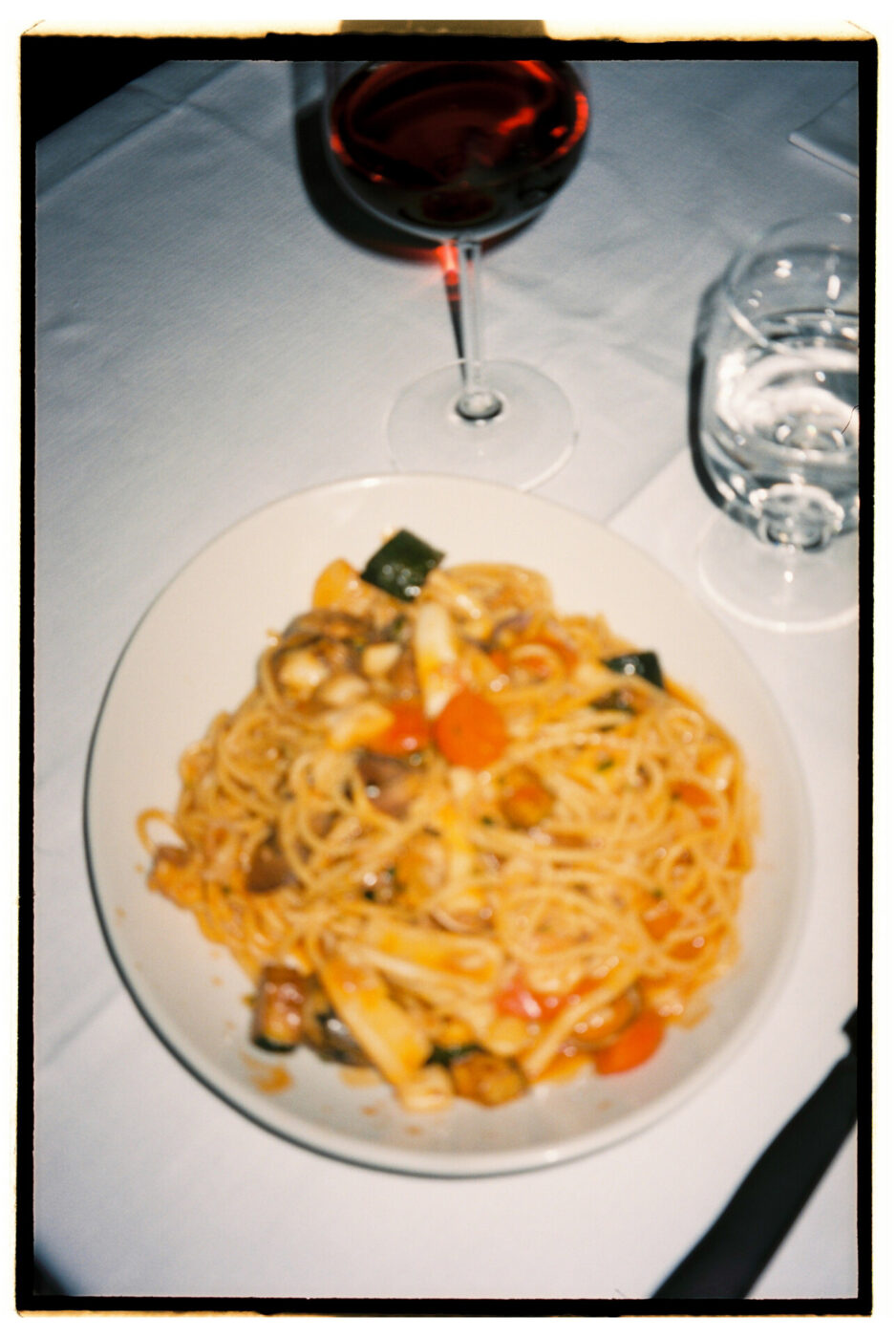 trattoria del cavaliere - a photo taken overhead in the inside of a restaurant dish of pasta with a glass of red wine
