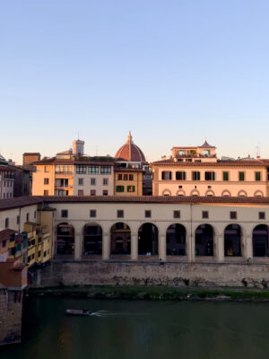 florence at sunset showing the Arno, the ponte vecchio, and the duomo poking up in the background