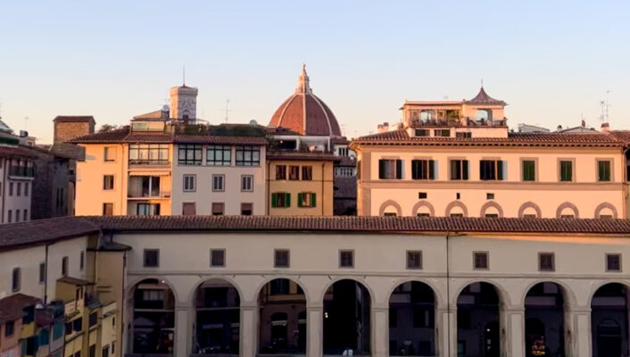 florence at sunset showing the Arno, the ponte vecchio, and the duomo poking up in the background