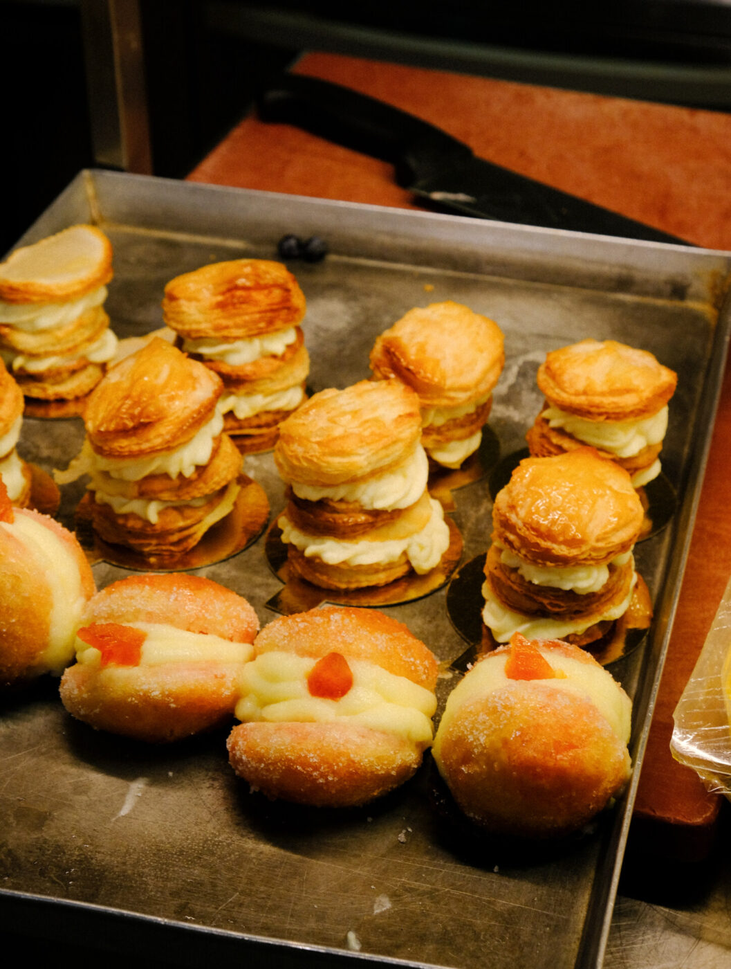 a tray with different desserts - bomboloni and pastry with cream - at Cibreo