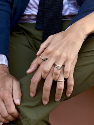 a photo of a man sitting and a woman's hand reached around and set on top of his