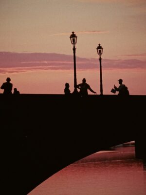 a bright pink sunset over the Arno in Florence