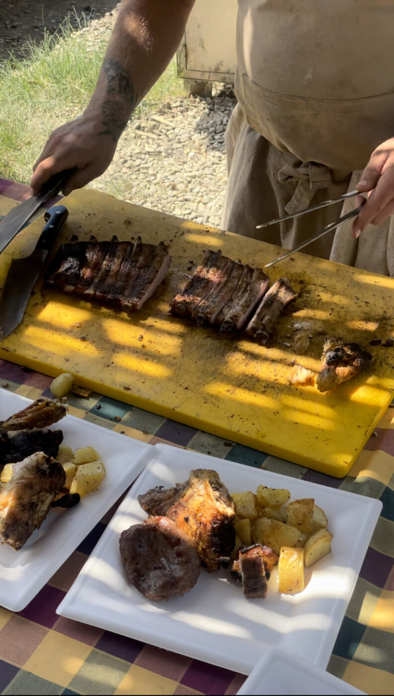 a man slicing steak and serving it with potatoes at Fattoria di Maiano