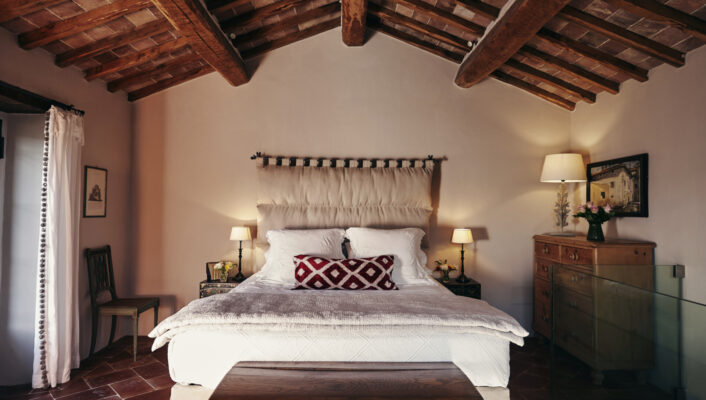 the bedroom at Le Caviere with a large white bed and slanted wooden roof