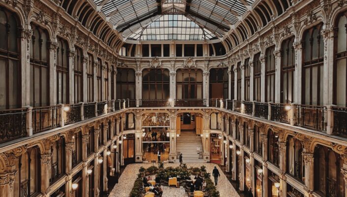 a photo in the Galleria Subalpina in Turin taken from above showing empty tables in the center