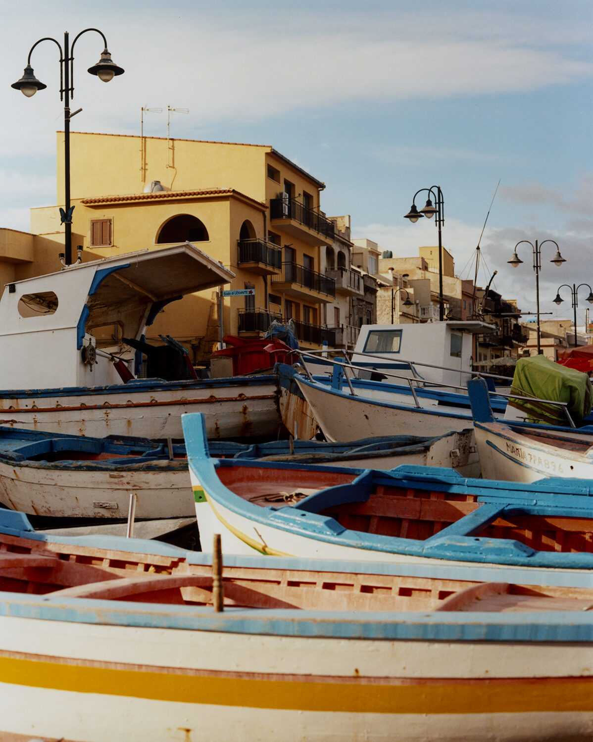 a photo of many brightly colored boats pulled up in Palermo - photo by Carlo Piro