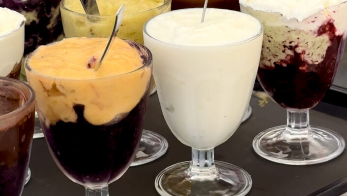 a platter with 10 different glasses of granita filled perfectly to the top with brightly colored irce