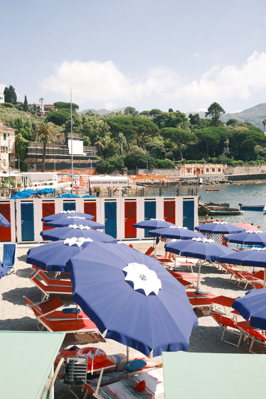 a bagni at portofino filled with blue umbrellas