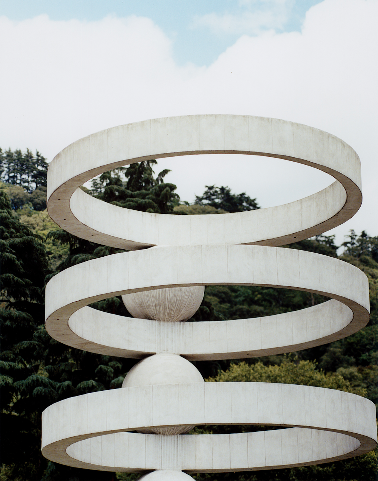 photo by Carlo Piro of rationalist architecture that is 3 white rings stacked with space between