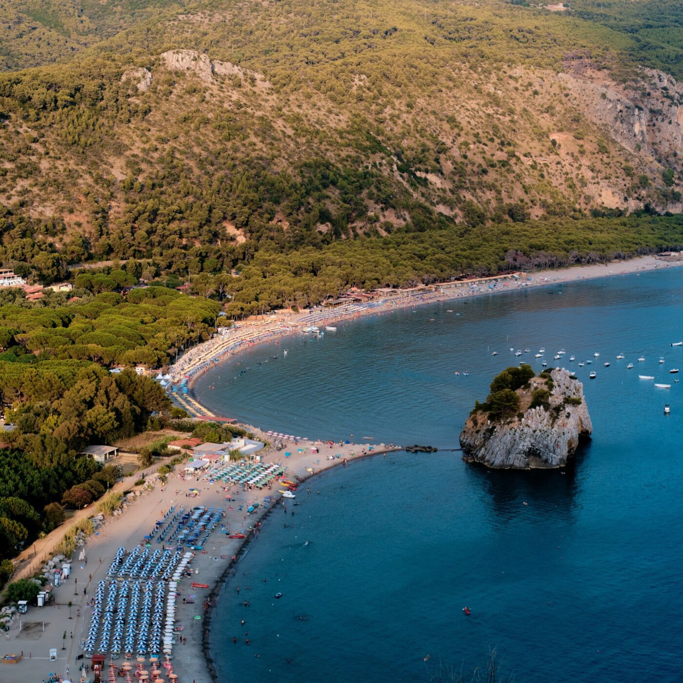 the Cliento coast of curved beaches lined with umbrellas, aqua water, and tree-lined hills