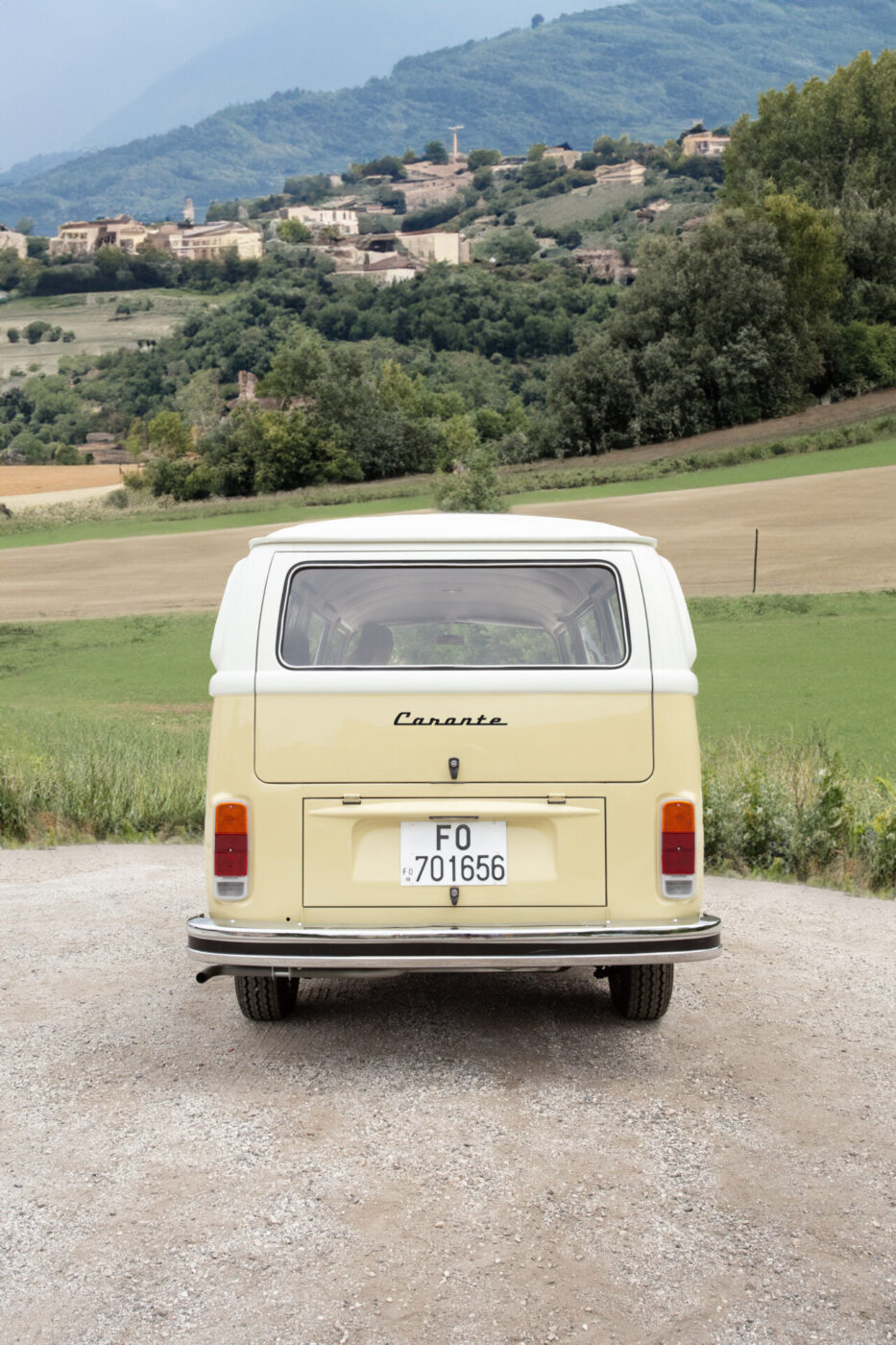 the back of a yellow van parked by the countryside