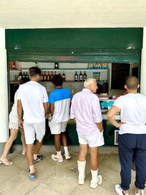 five people standing at the bar in a circolo all dressed in athletic wear