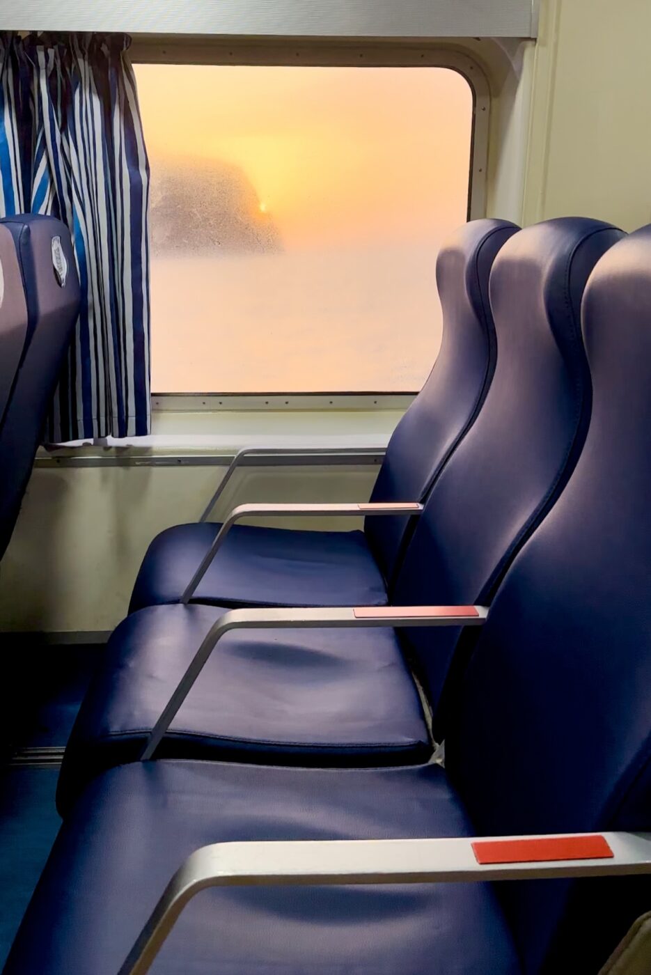 a view of empty train seats and a foggy window
