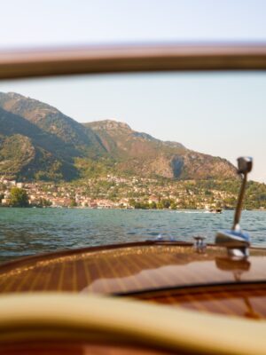 a view of a lake through the windshield of a boat