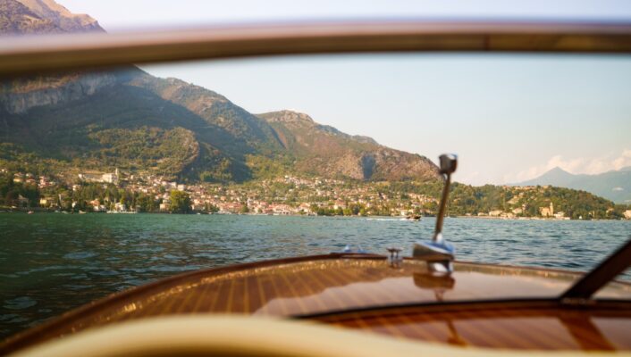 a view of a lake through the windshield of a boat