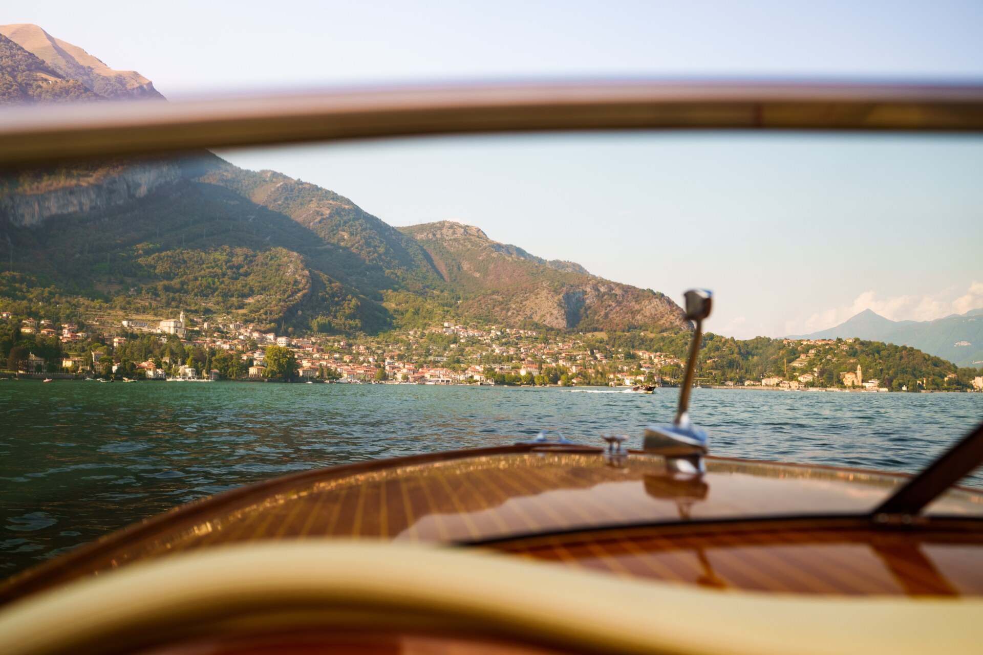a view of a lake through the windshield of a boat