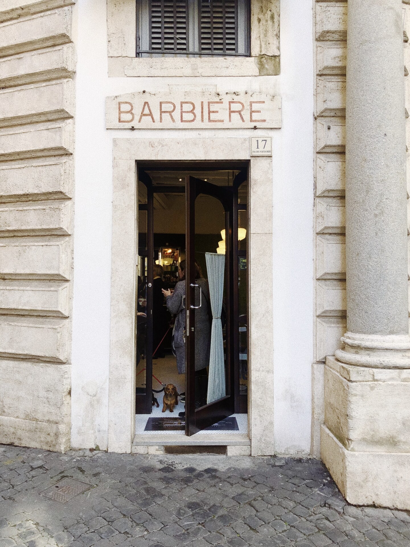 a small door with a sign for a barbiere