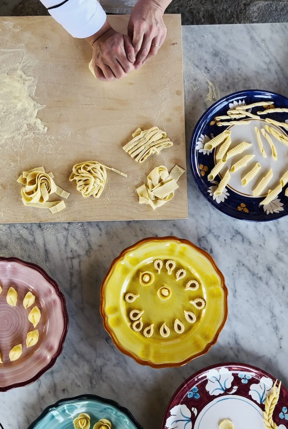 an overhead photo of lots of different types of homemade pasta