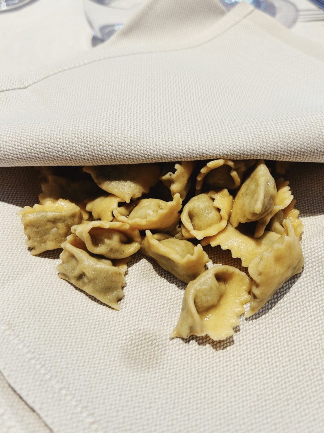 small ravioli al plin served in a napkin at Battaglino in Bra